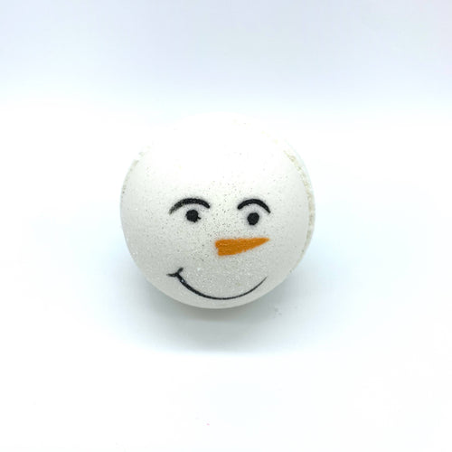 Bombe de bain blanche de forme sphérique peinte à la main avec un visage de bonhomme de neige.